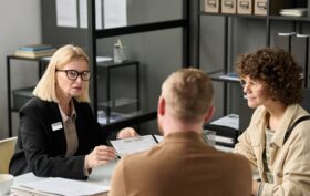 Female insurance broker consulting couple