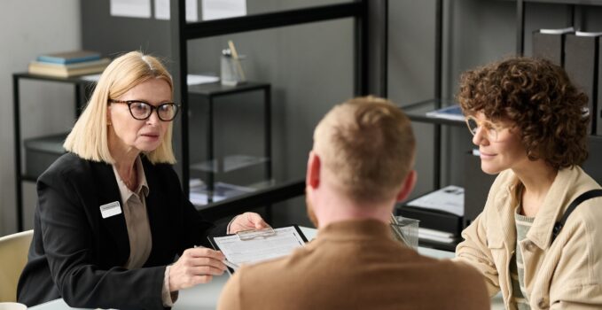 Female insurance broker consulting couple